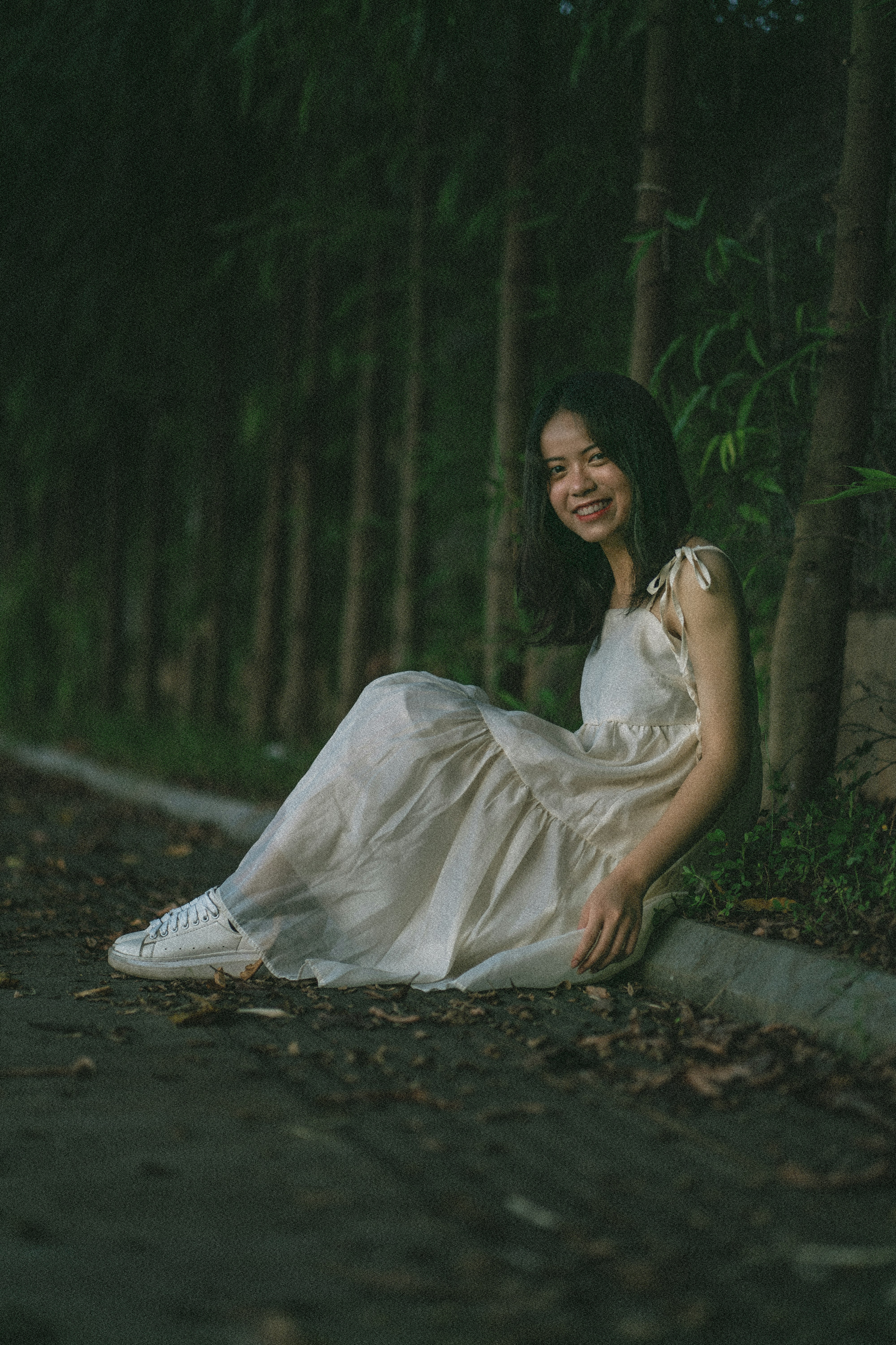 woman in white dress sitting on ground